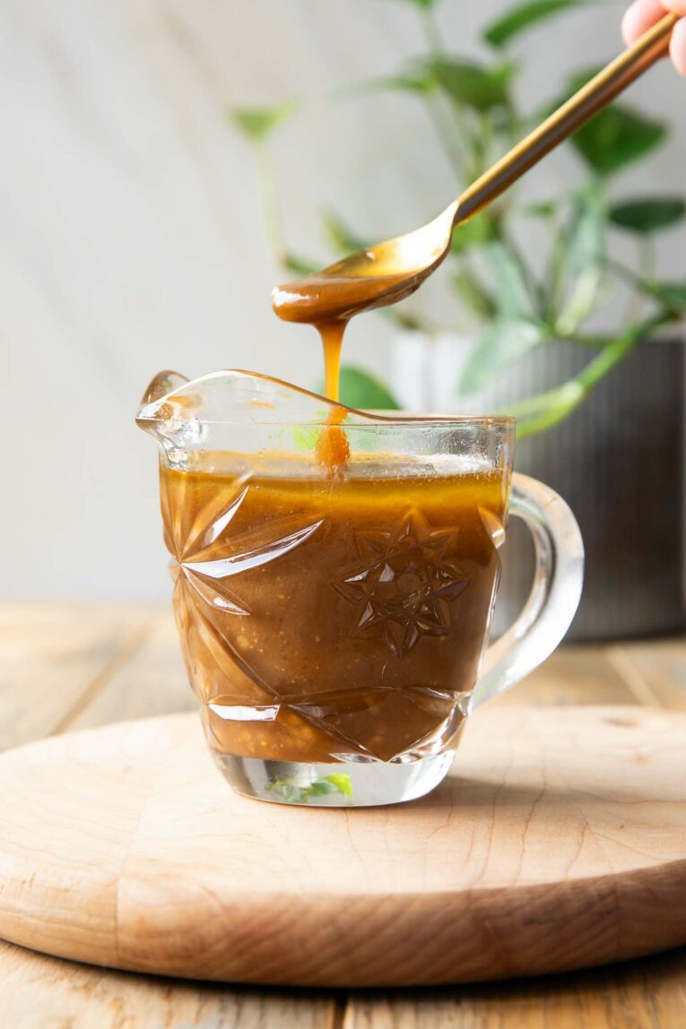 Spoon dipping into Balsamic Vinaigrette.