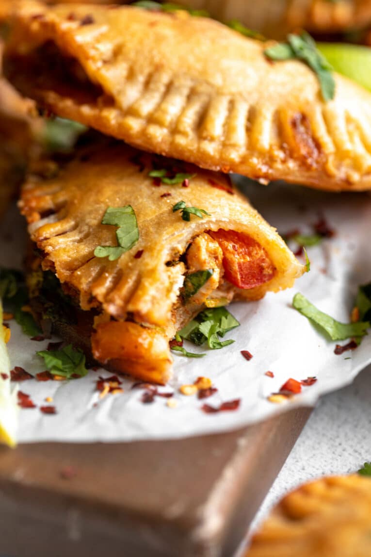 Angled close up of Chicken Empanada with bite taken out.