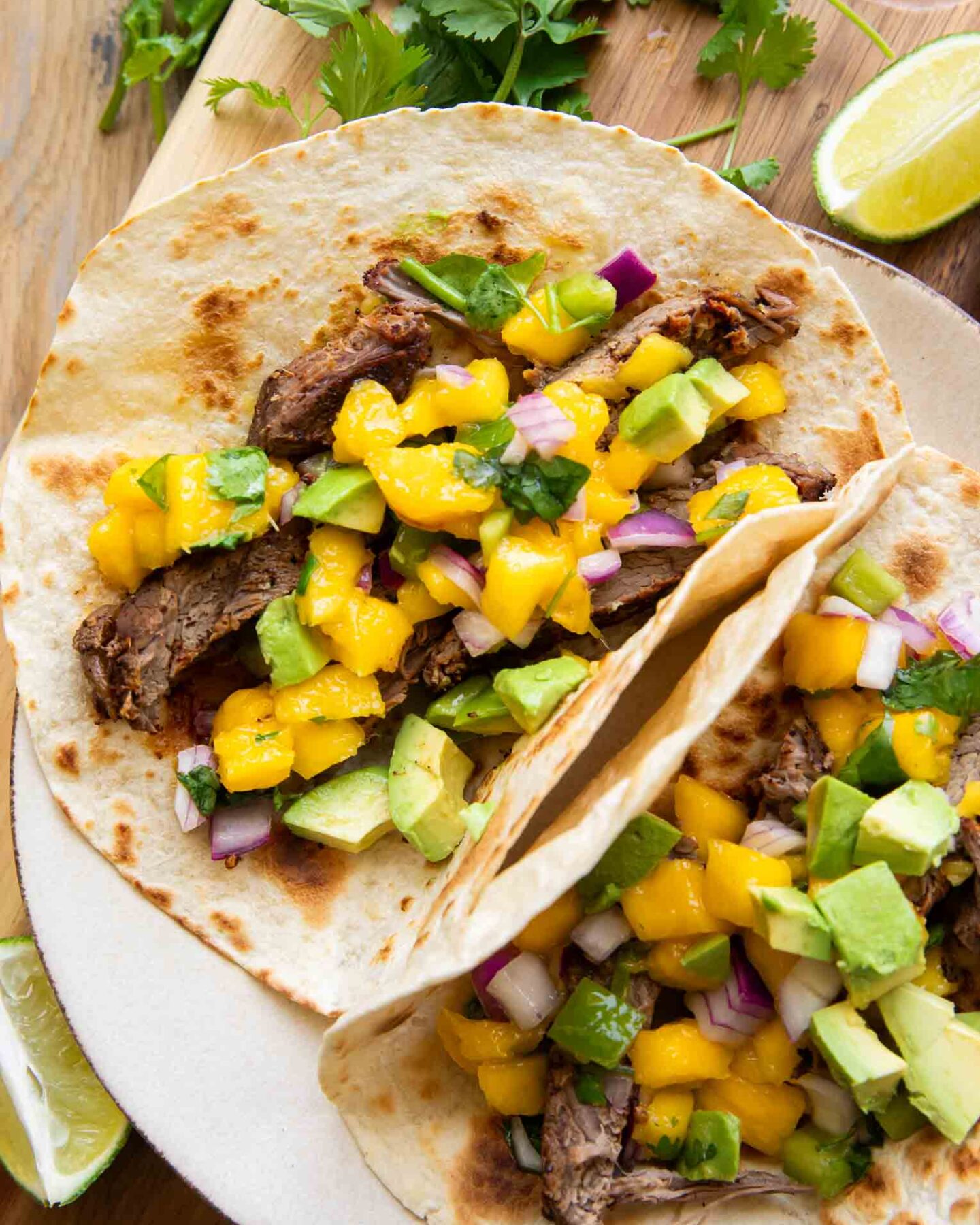Close up of plated Chili Lime Steak Tacos w/ Mango Salsa.