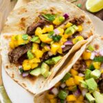 Close up of plated Chili Lime Steak Tacos w/ Mango Salsa.