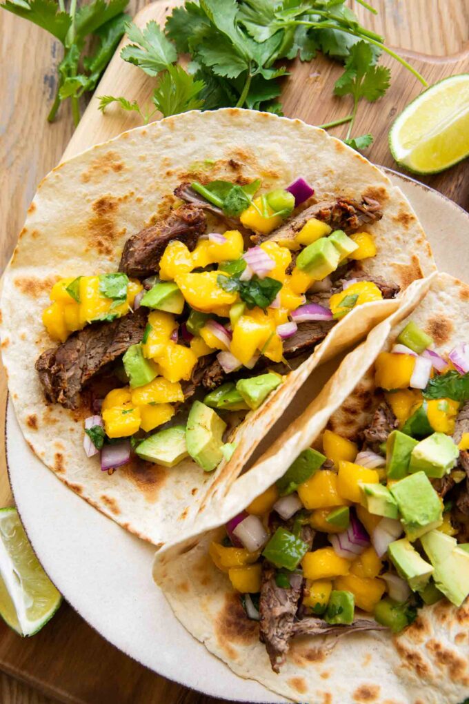Close up of plated Chili Lime Steak Tacos w/ Mango Salsa.