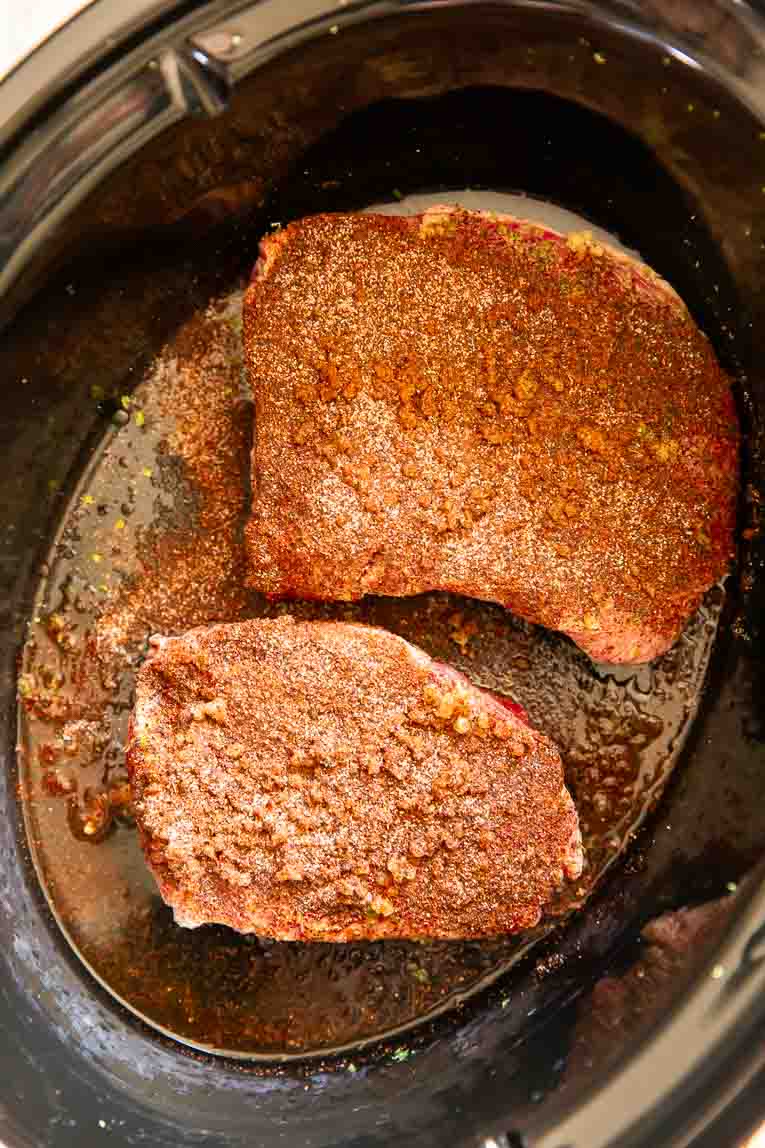 Steaks with chili lime seasoning in a slow cooker.