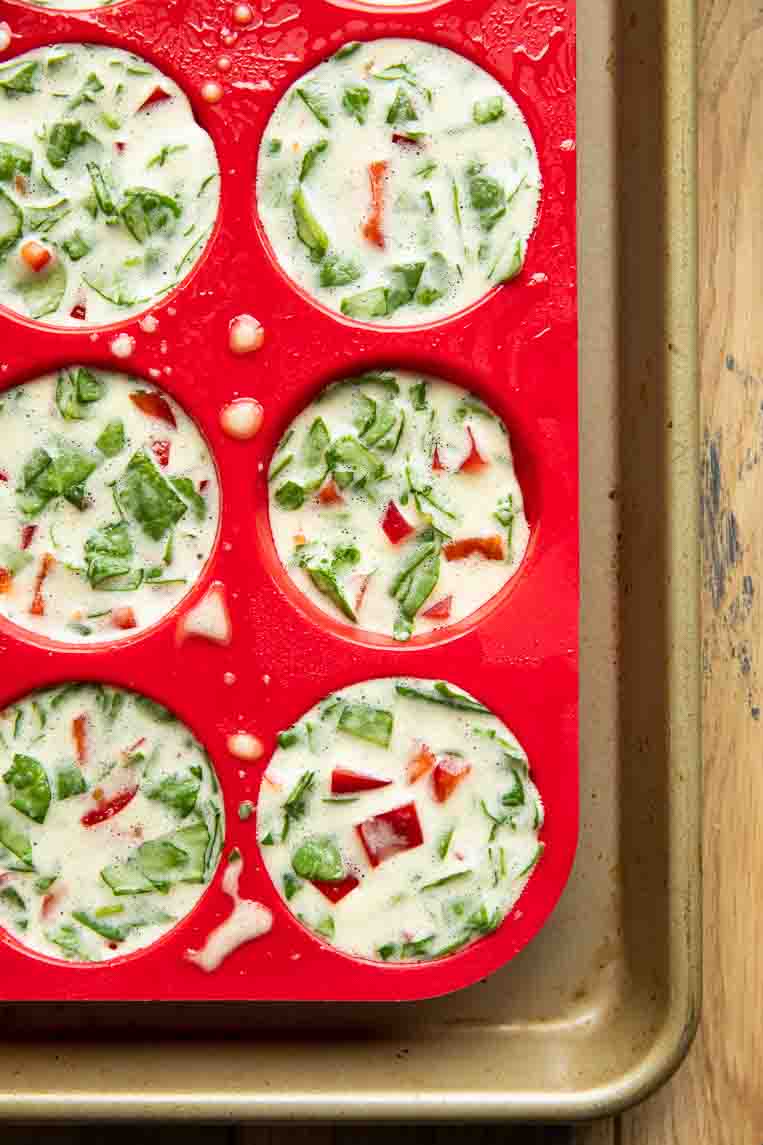 Raw egg bites in a muffin tin.