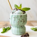 Close up of Healthy Mint Chocolate Chip Ice Cream scoops in a glass.