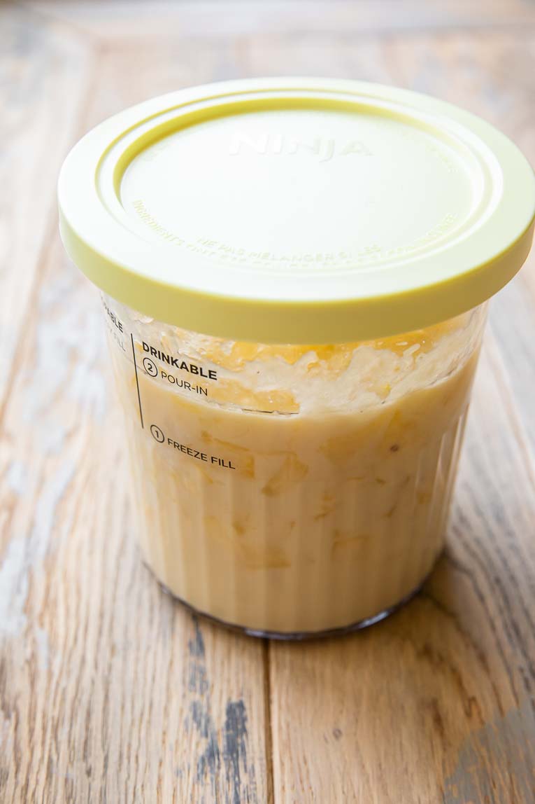 Ingredients for dole whip in a creami container.