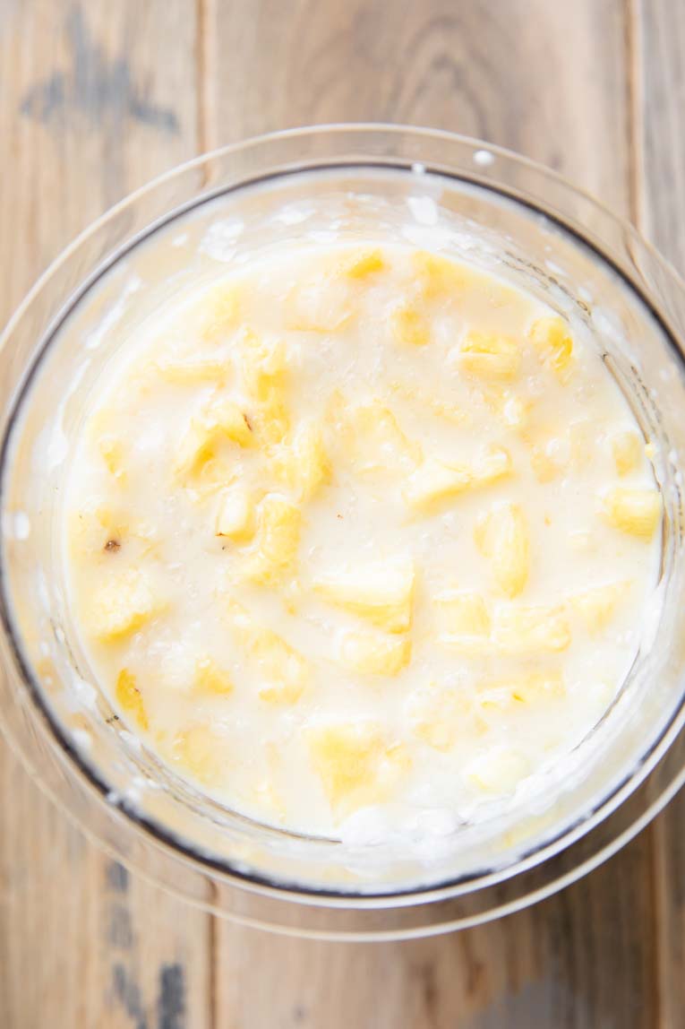 Top shot of ingredients for Ninja Creami Dole Whip in container.