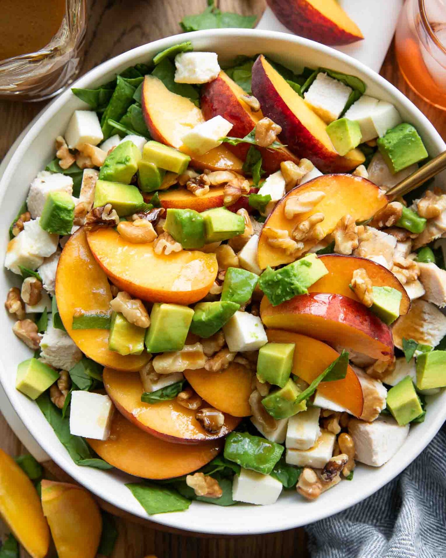Peach Mozzarella Salad recipe on a plate with ingredients around it.