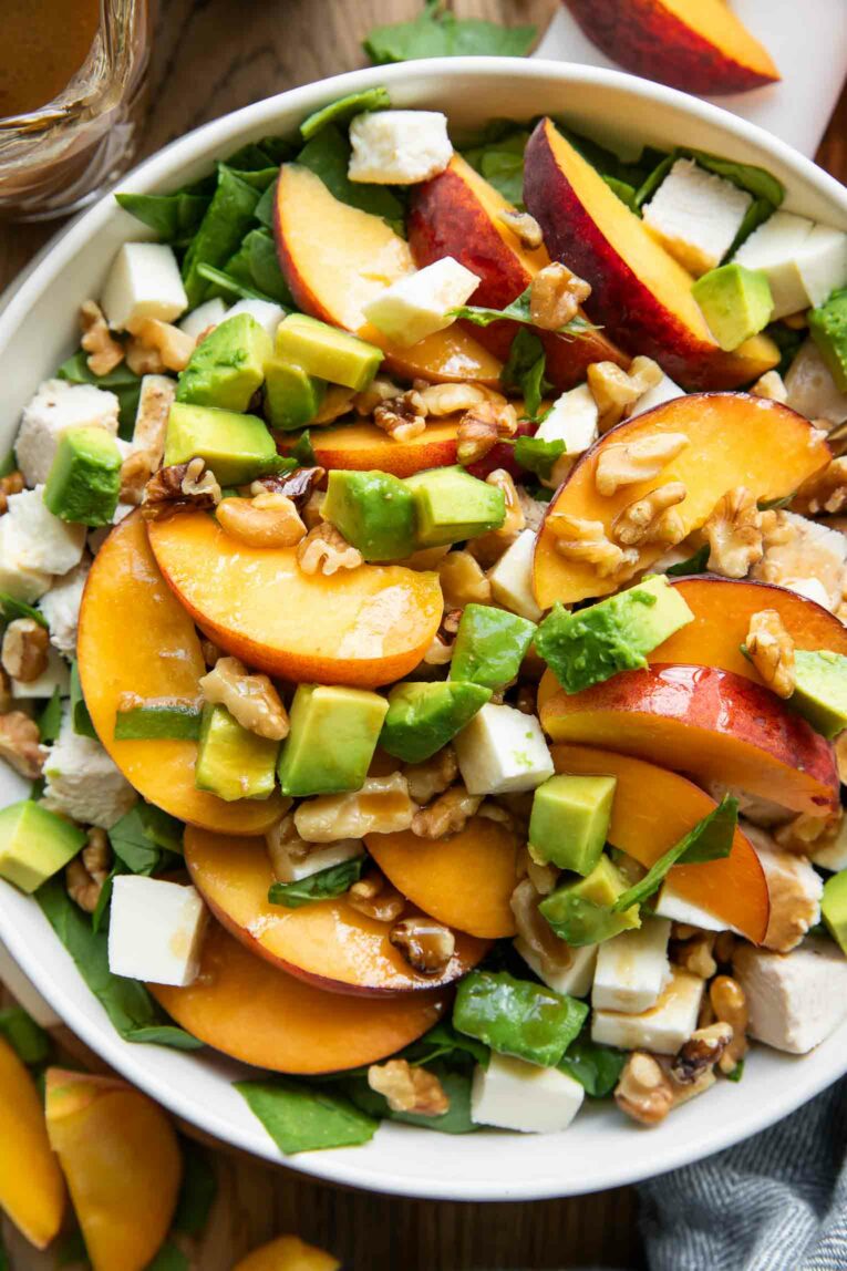 Close up of peach salad with mozzarella and avocado.