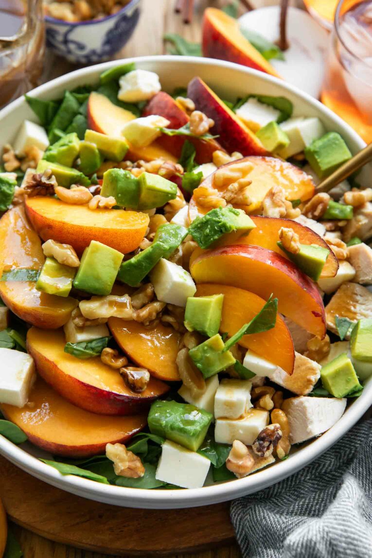Angled photo of peach salad recipe on a plate.