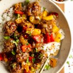 Sweet & sour meatballs with stir fry in a bowl.
