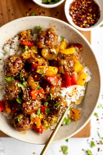 Sweet & sour meatballs with stir fry in a bowl.