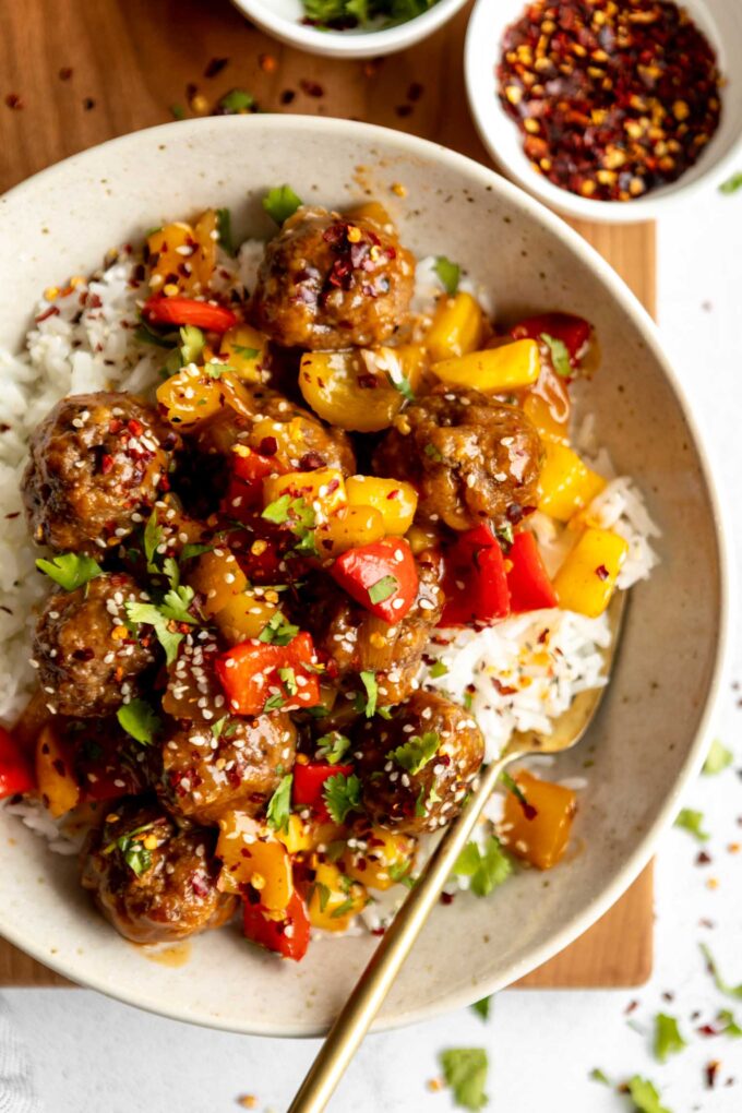Sweet & sour meatballs with stir fry in a bowl.