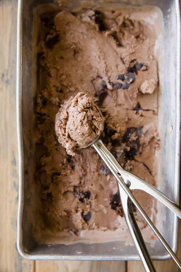 Frozen Brownie batter Ice Cream being scooped out.