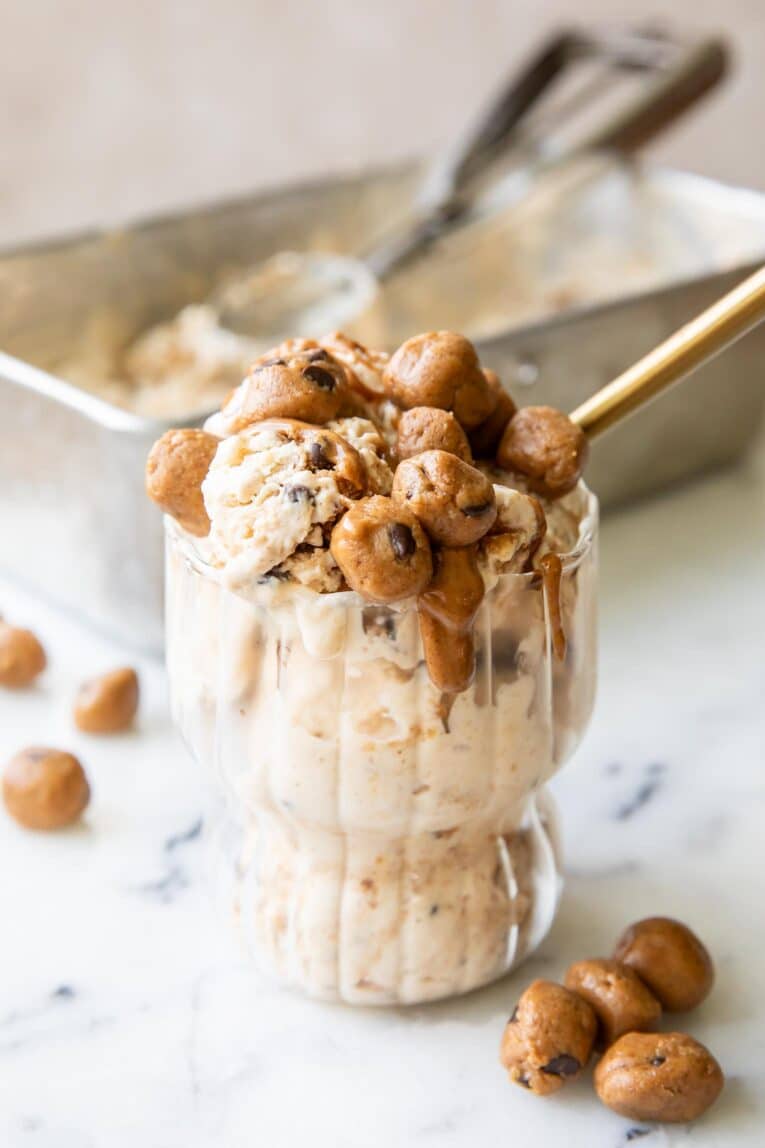 Angled photo of creamy Cookie Dough Ice Cream in a parfait glass.