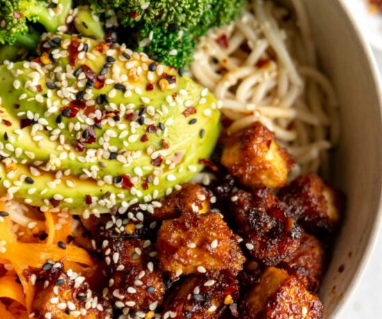 Asian fried tofu with avocado, veggies, and noodles.