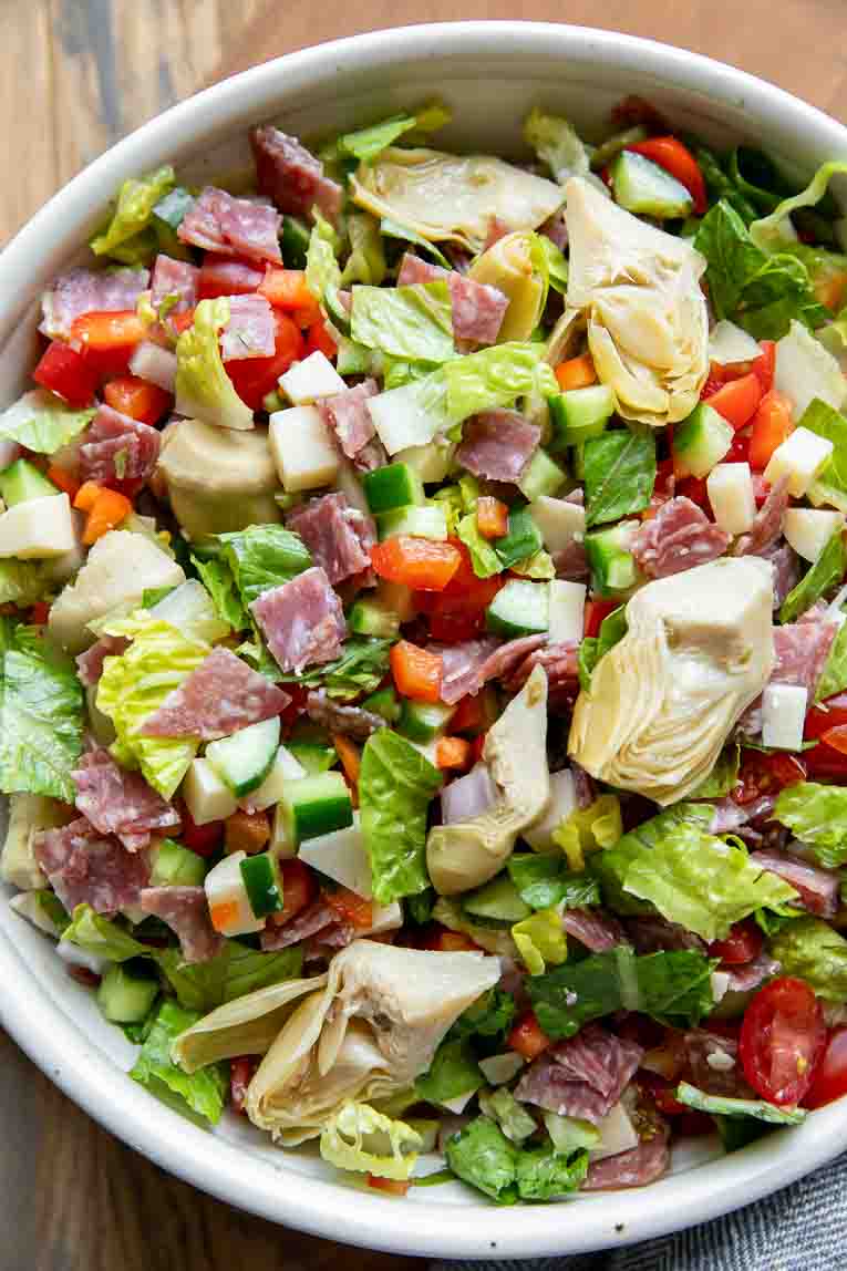 Chopped Salad being mixed together.