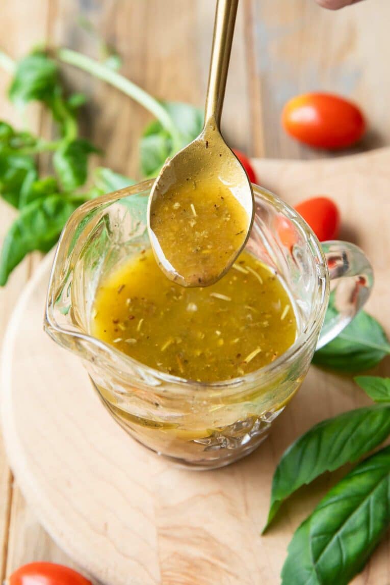 Angled photo of Italian Dressing Recipe with spoonful of dressing.