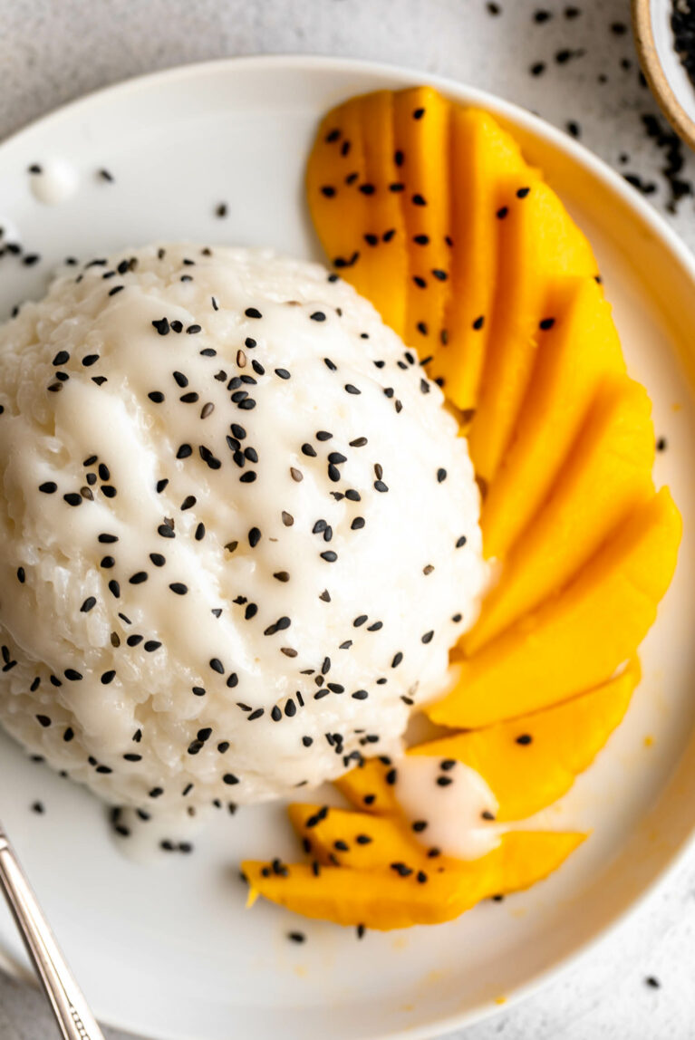 Top shot of Mango Sticky Rice with fresh mangos and sesame seeds.
