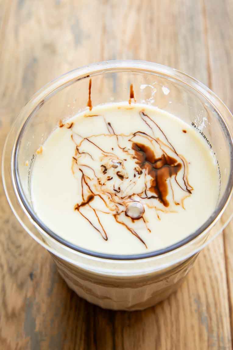 Protein ice cream base ingredients mixed in a Ninja Creami container.