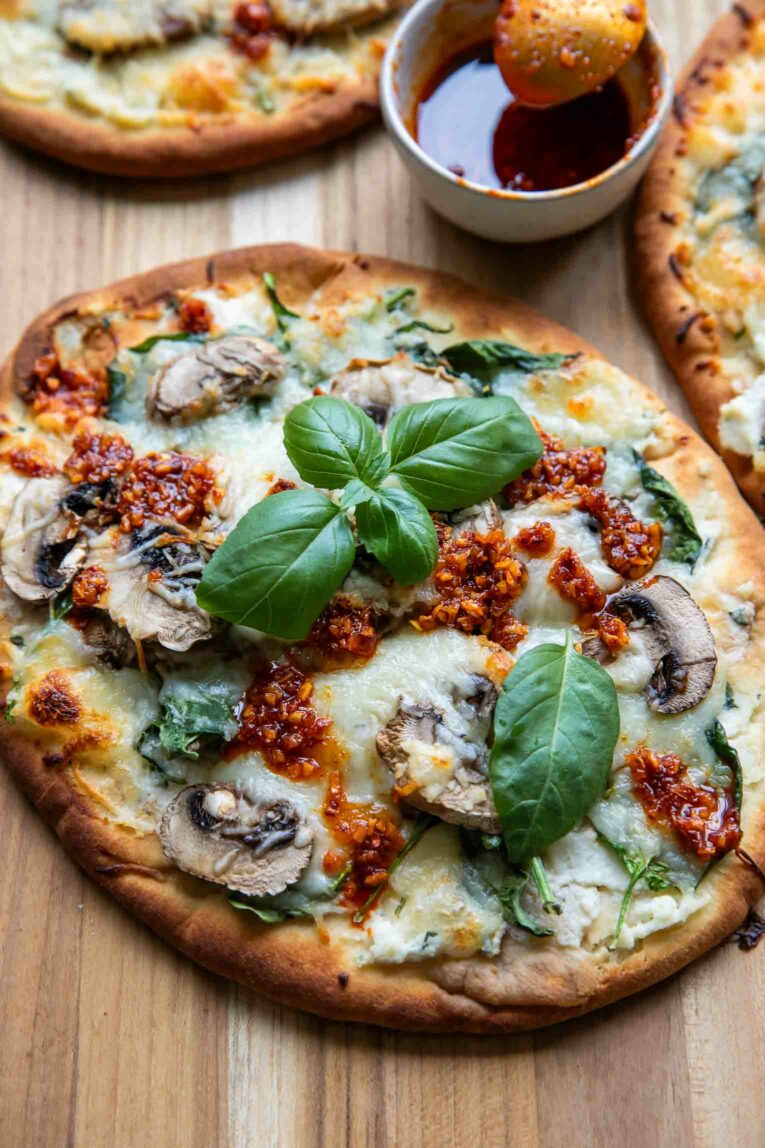 Angled photo of Spinach & Mushroom Naan Pizza.