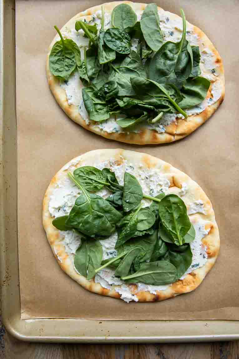 Naan bread topped with ricotta and spinach.