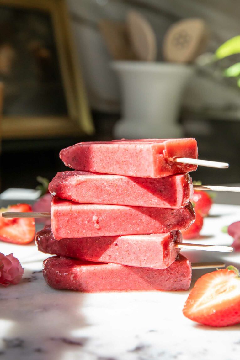 Strawberry Chia Seed Popsicles stacked for healthy treat.