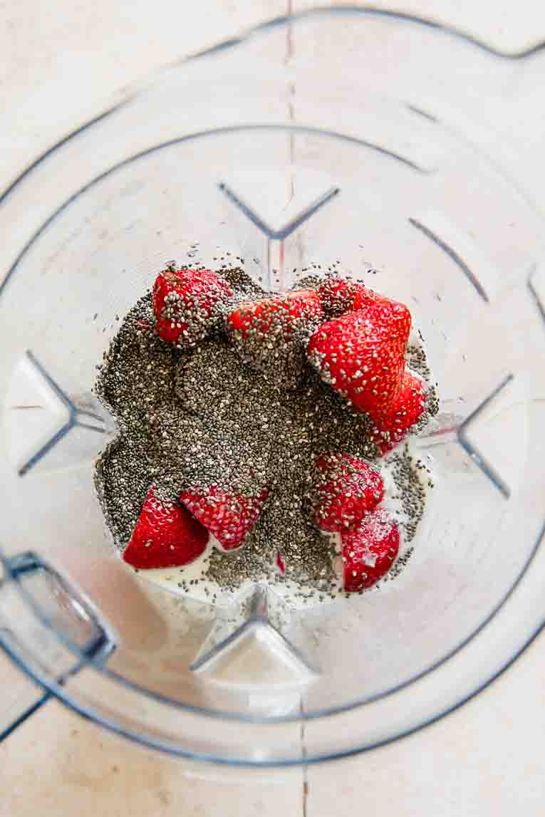 Ingredients for Strawberry Chia Seed Popsicles in a blender.