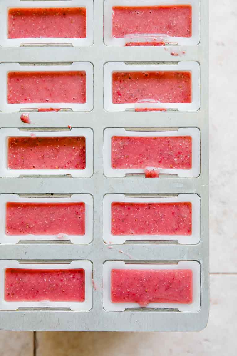 Strawberry Popsicles mixture in popsicle mold.