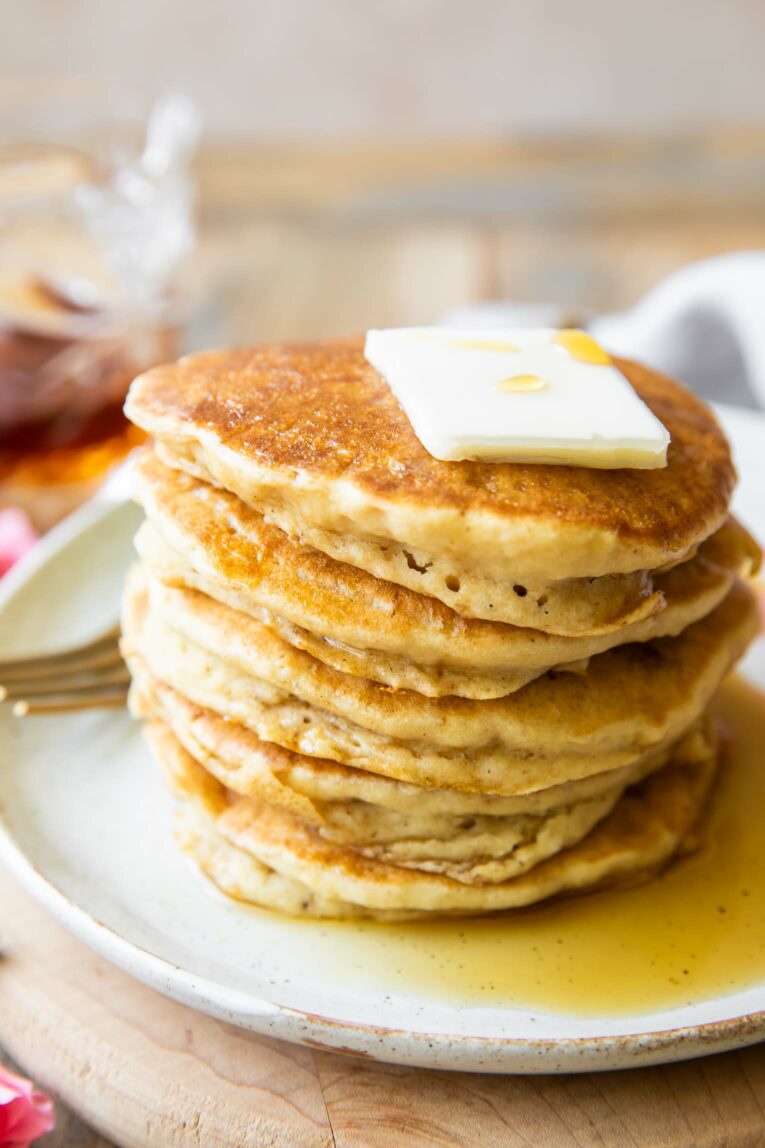 Angled photo of Gluten-Free Pancakes with butter cube.