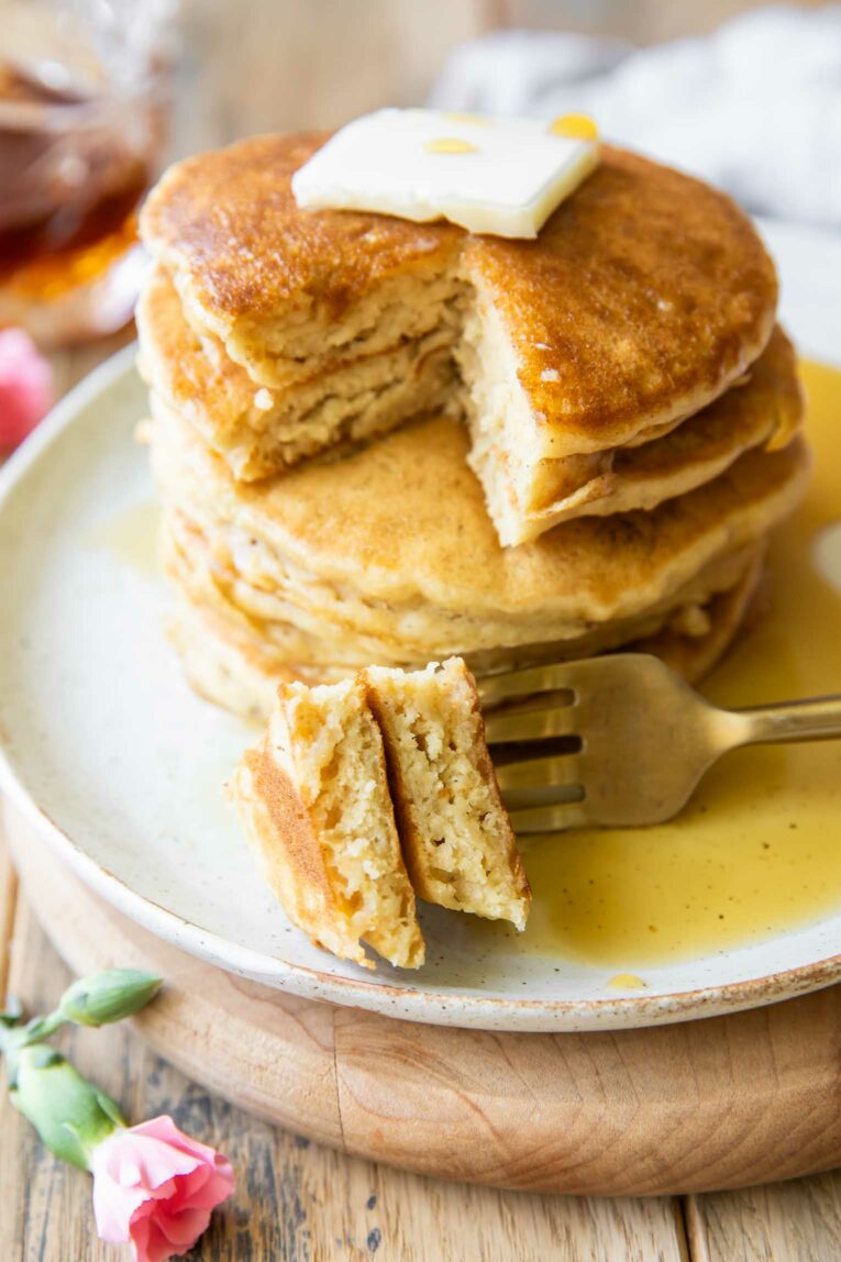 Gluten-Free Pancakes stacked with fork taking bite.