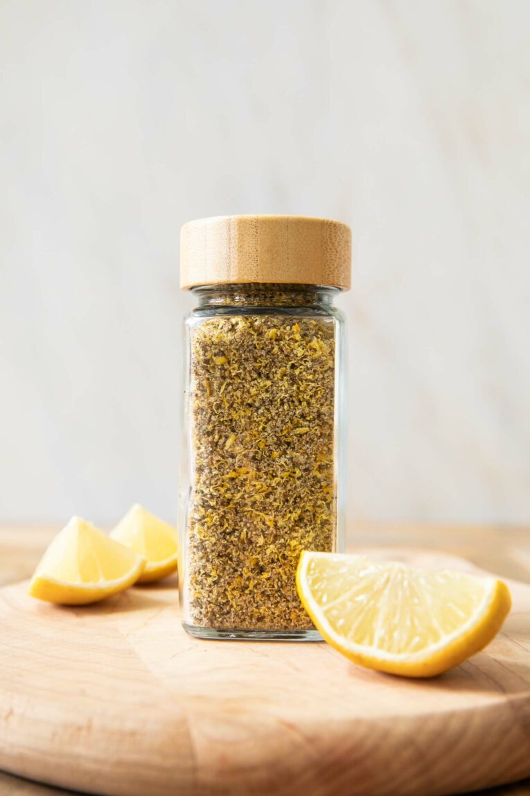 Across photo of Lemon Pepper Seasoning with lemon slices.