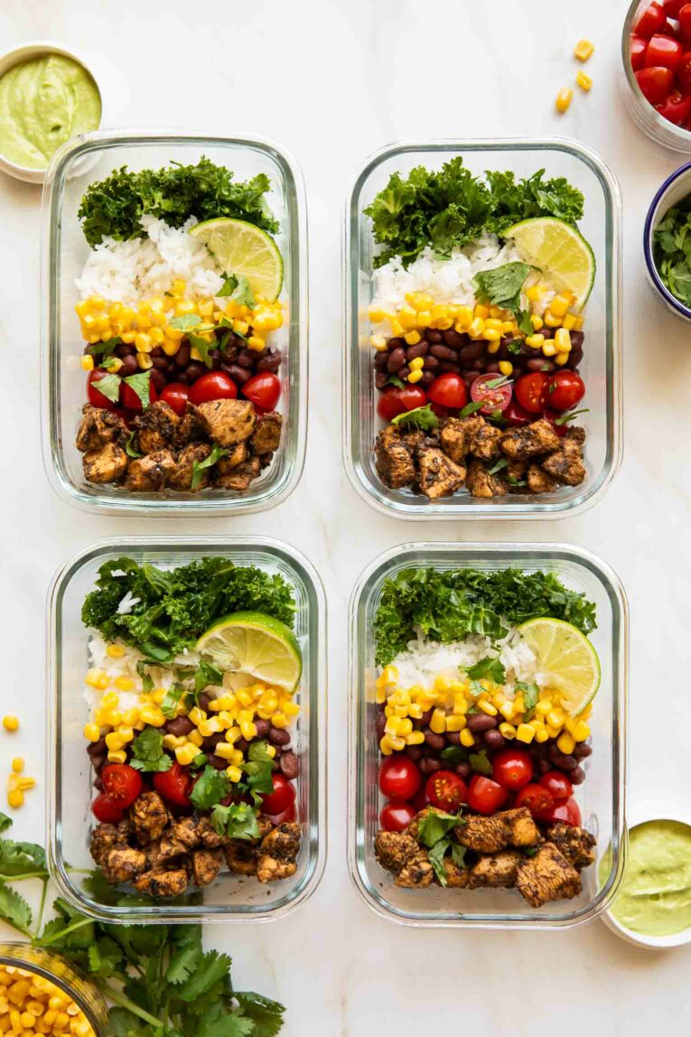 Chicken burrito bowls in meal prep containers.