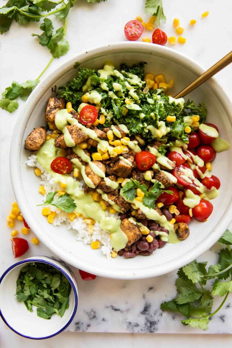 Meal Prep Southwest Chicken Burrito Bowl with avocado dressing.