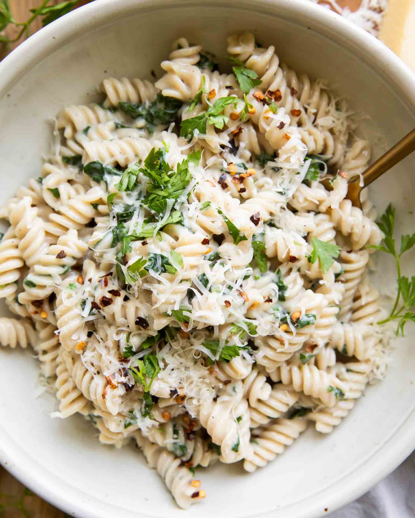 Protein Pasta Recipe in a bowl with spinach and parsley.