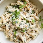 Protein Pasta Recipe in a bowl with spinach and parsley.