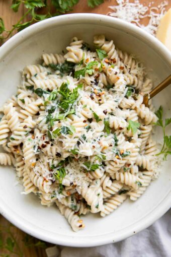 Protein Pasta Recipe in a bowl with spinach and parsley.