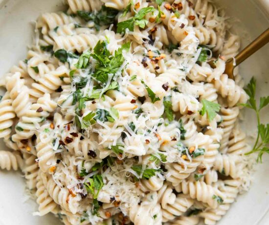 Protein Pasta Recipe in a bowl with spinach and parsley.