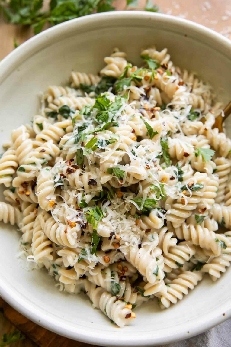 Angled photo of protein pasta with cottage cheese sauce and spinach.