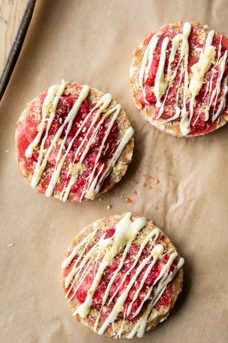 Strawberry cheesecake rice cakes on parchment paper.