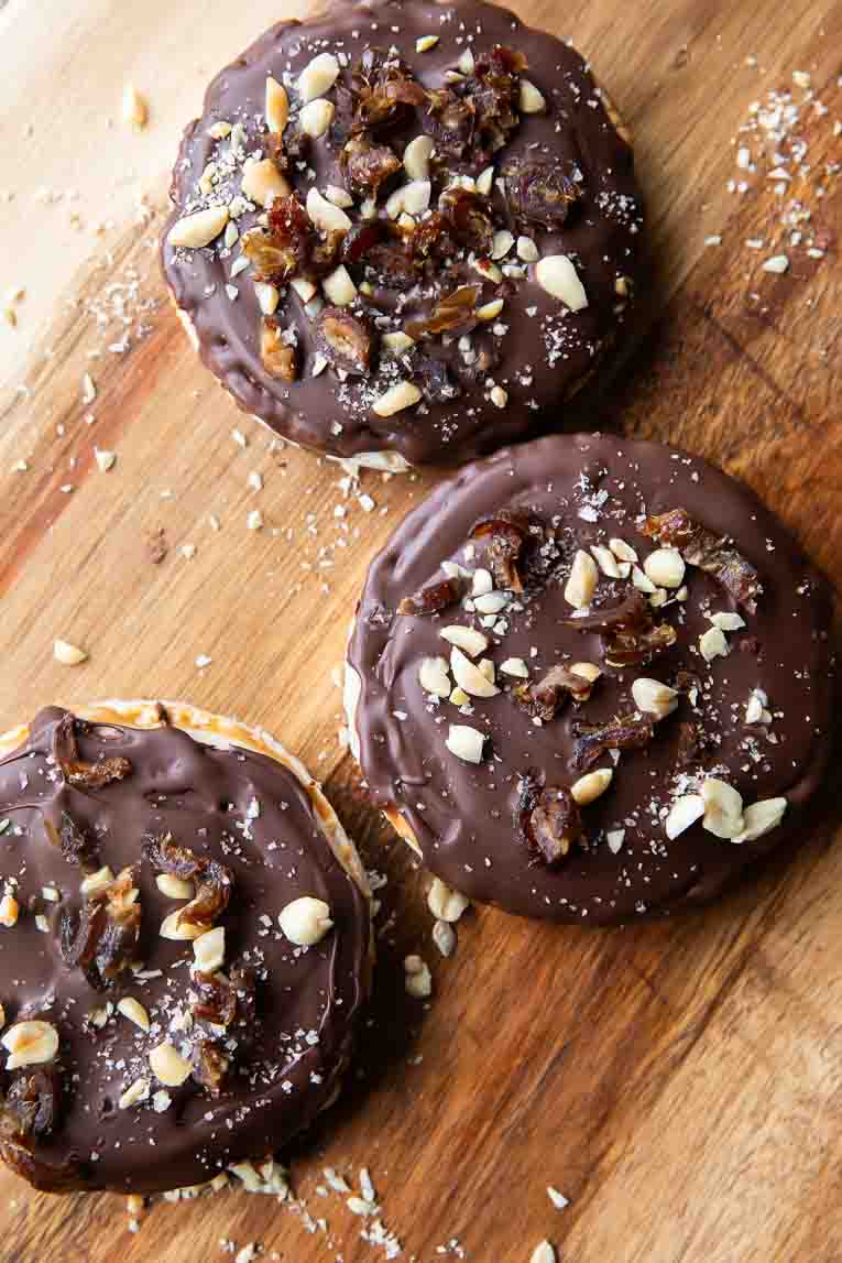 Healthy snicker rice cakes on a cutting board.