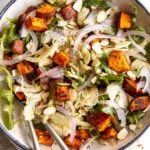 Close up of shaved fennel salad with sweet potatos on a plate.