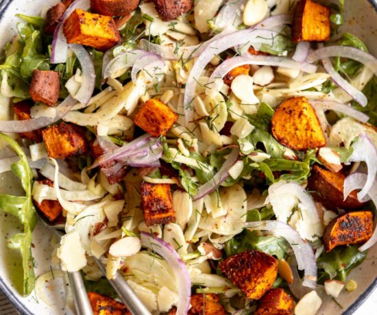 Close up of shaved fennel salad with sweet potatos on a plate.
