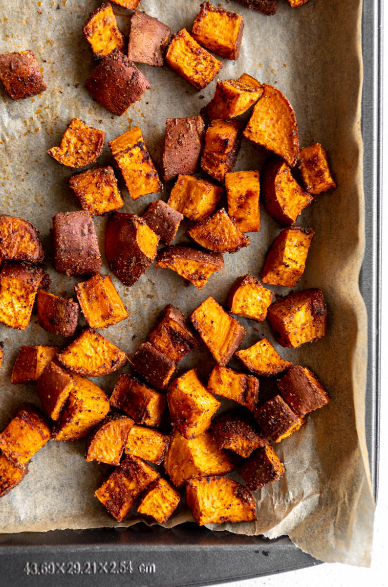 Roasted sweet potatoes on a baking pan.