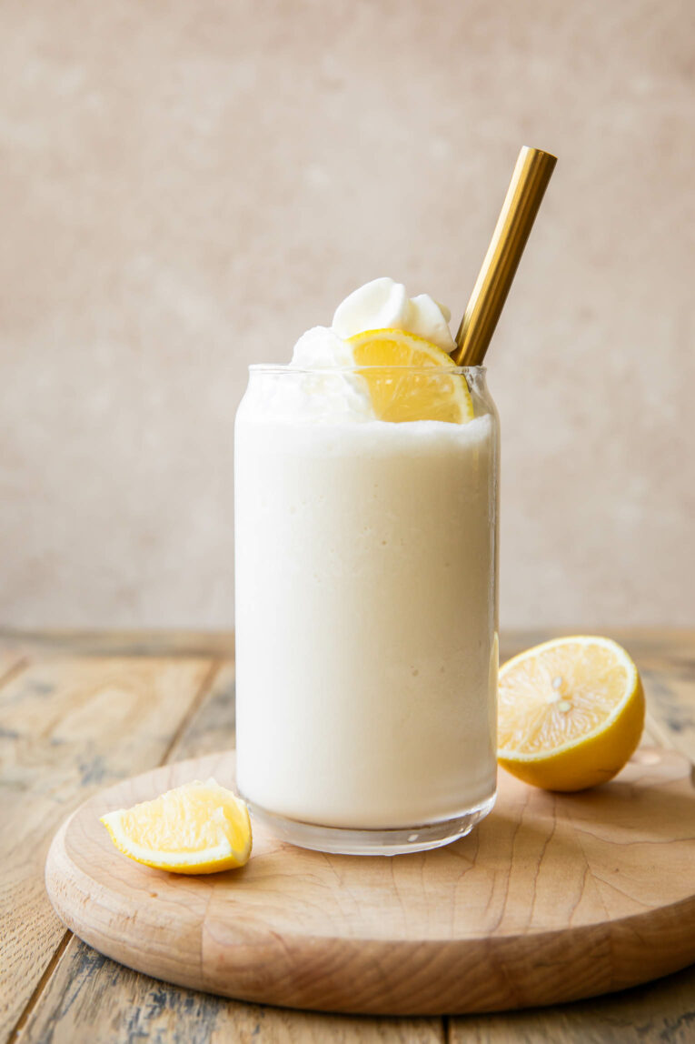 Whipped Frozen Lemonade in a glass with whipped cream.