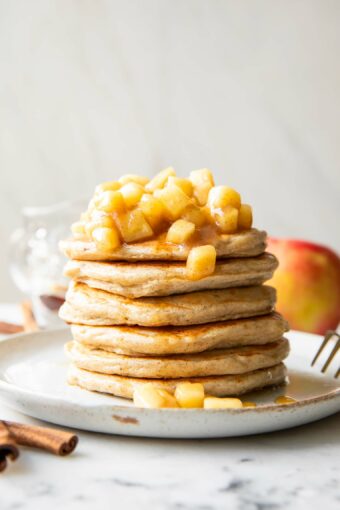 Apple Pie Protein Pancakes recipe stack of pancakes on a plate.