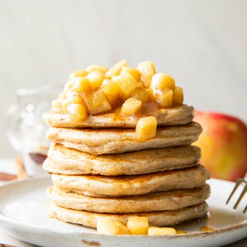 Apple Pie Protein Pancakes recipe stack of pancakes on a plate.
