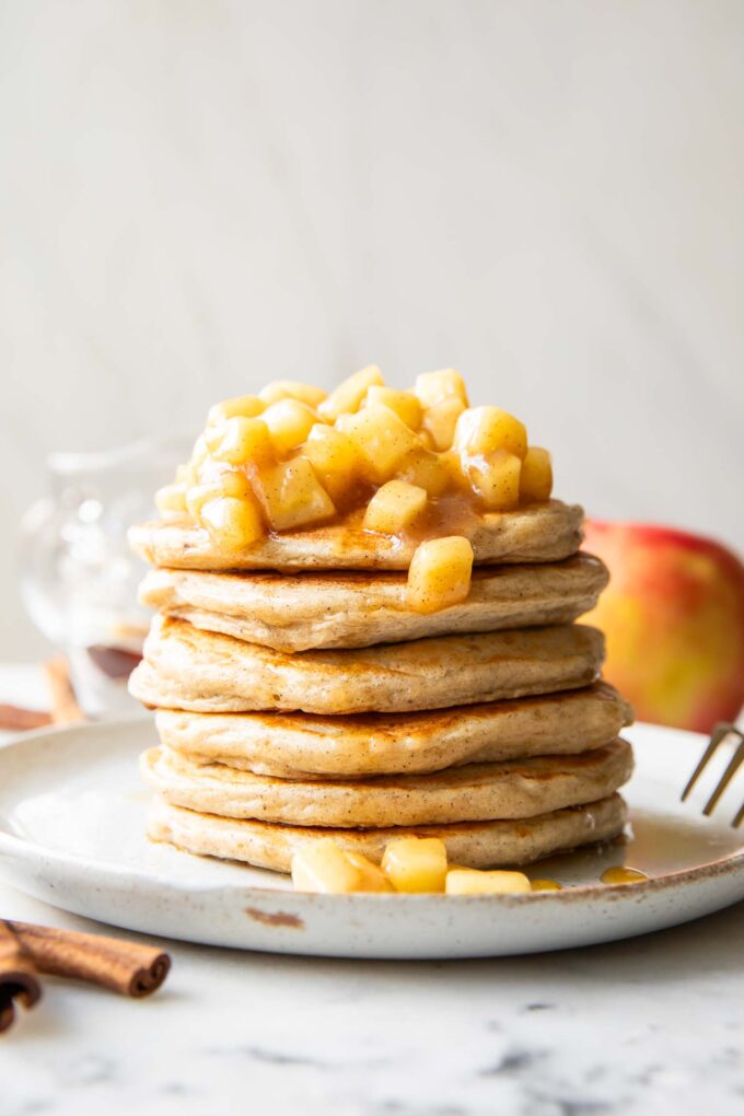 Apple Pie Protein Pancakes recipe stack of pancakes on a plate.