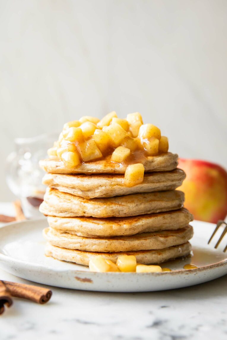 Apple Pie Protein Pancakes recipe stack of pancakes on a plate.
