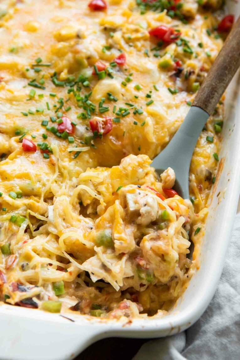 Spaghetti squash casserole in a dish with a spoon.