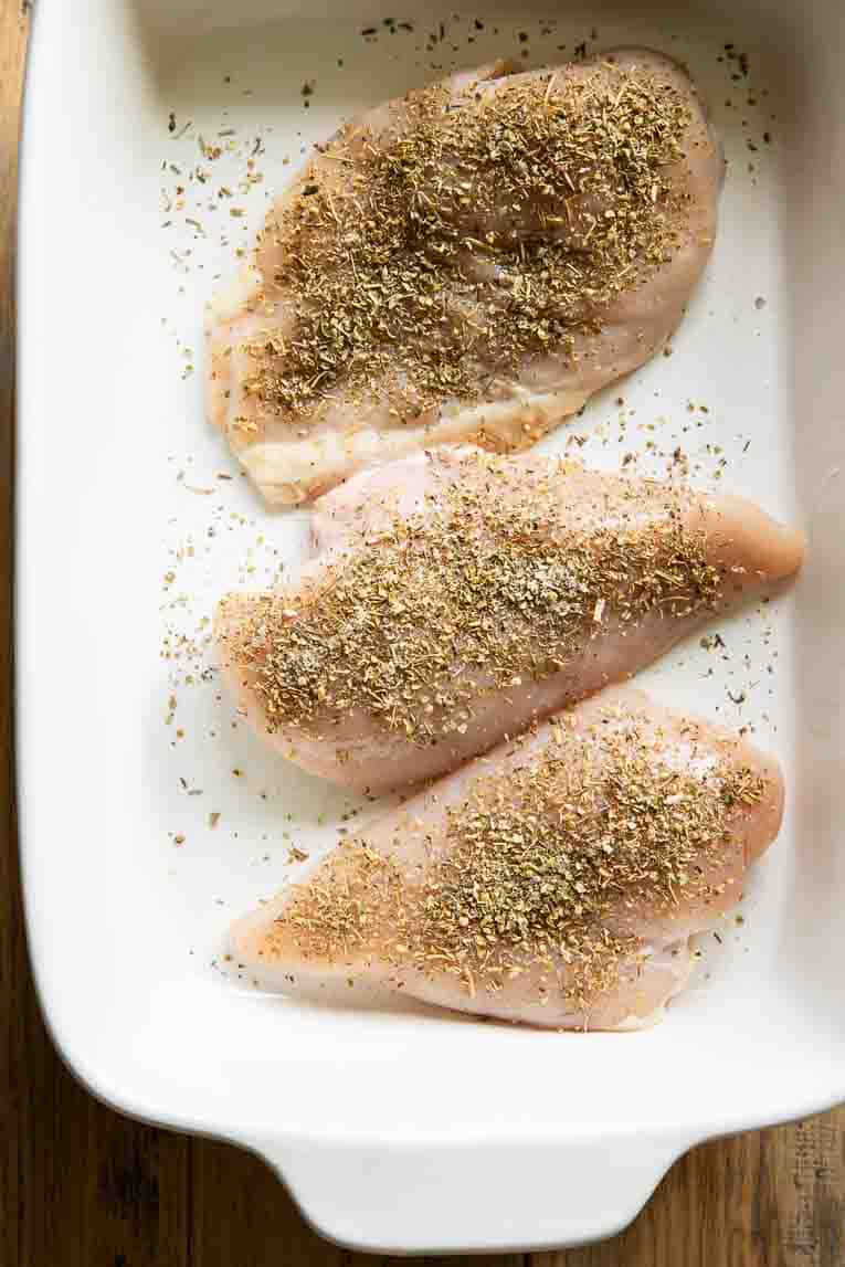 Chicken with Italian seasoning being baked.